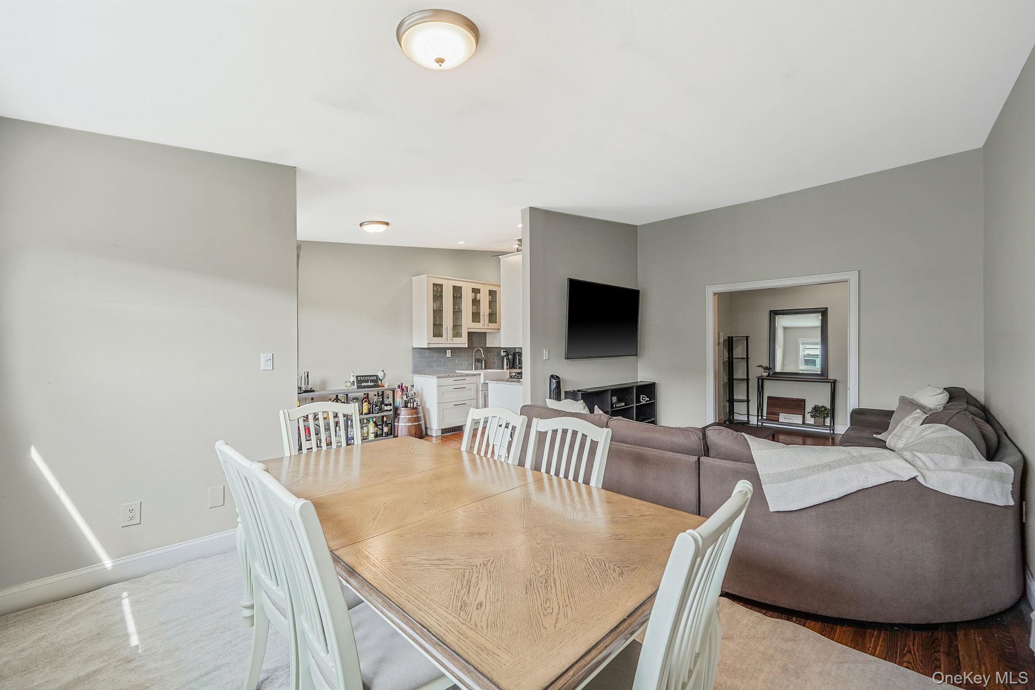 22 Ivy Street, Unit 6B Farmingdale, NY 11735 - Photo 11 of 26 a dining room with furniture and wooden floor