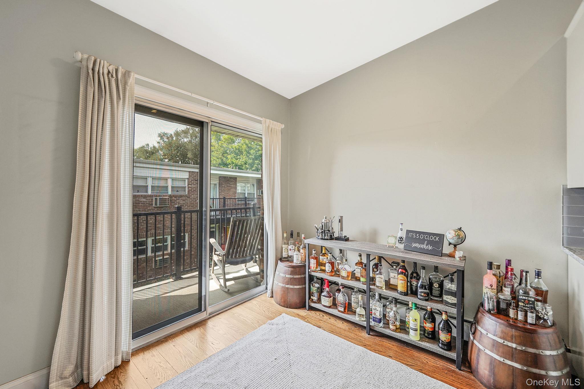 22 Ivy Street, Unit 6B Farmingdale, NY 11735 - Photo 12 of 26 a room with lots of furniture and a large window