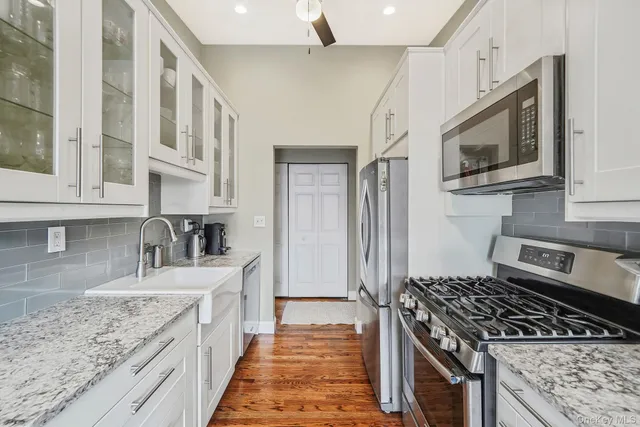 a kitchen with stainless steel appliances granite countertop a stove and a sink