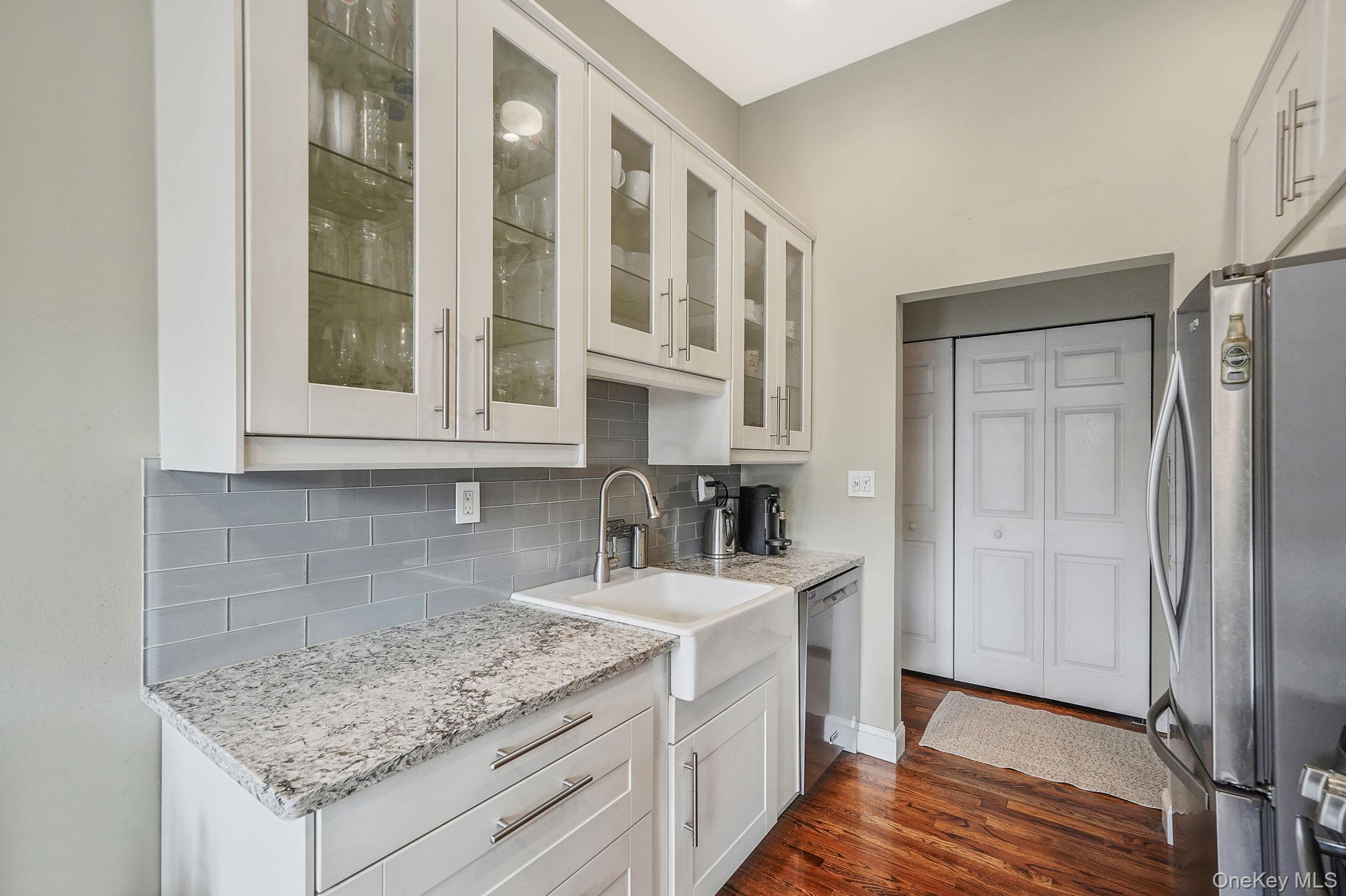 22 Ivy Street, Unit 6B Farmingdale, NY 11735 - Photo 15 of 26 a kitchen with stainless steel appliances granite countertop a sink and a refrigerator