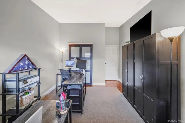a view of a livingroom with furniture and a flat screen tv