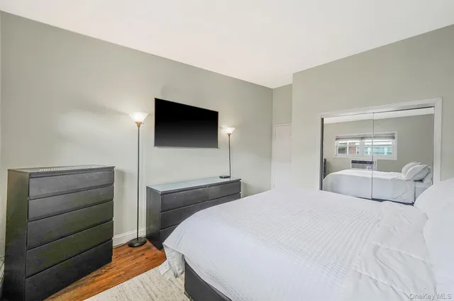 a bedroom with a bed and a mirror