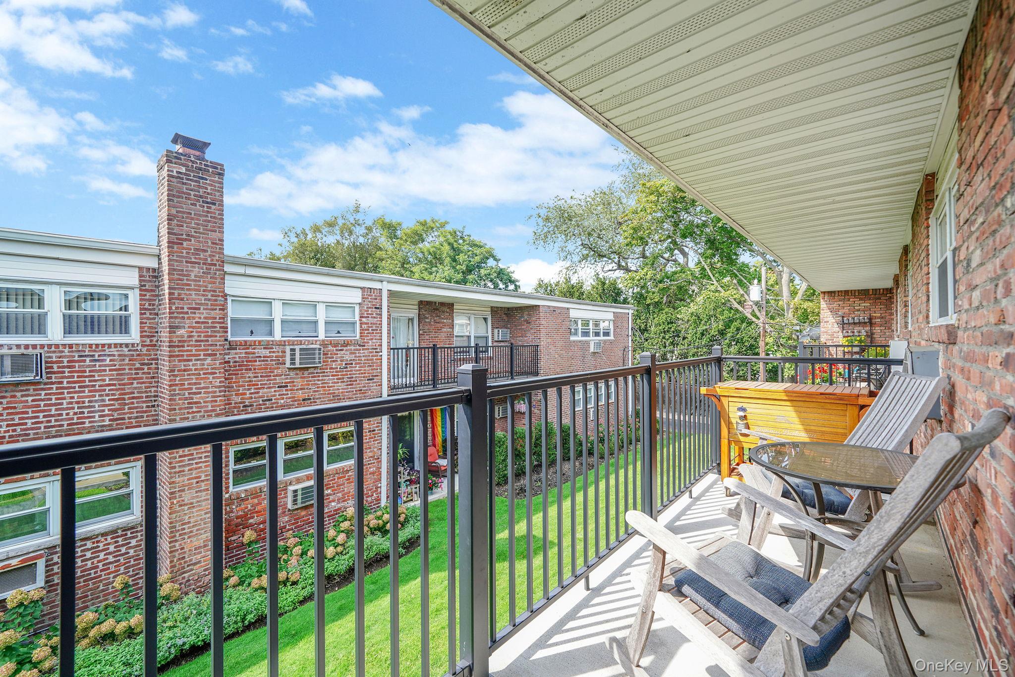22 Ivy Street, Unit 6B Farmingdale, NY 11735 - Photo 22 of 26 a view of a chair and tables in the balcony