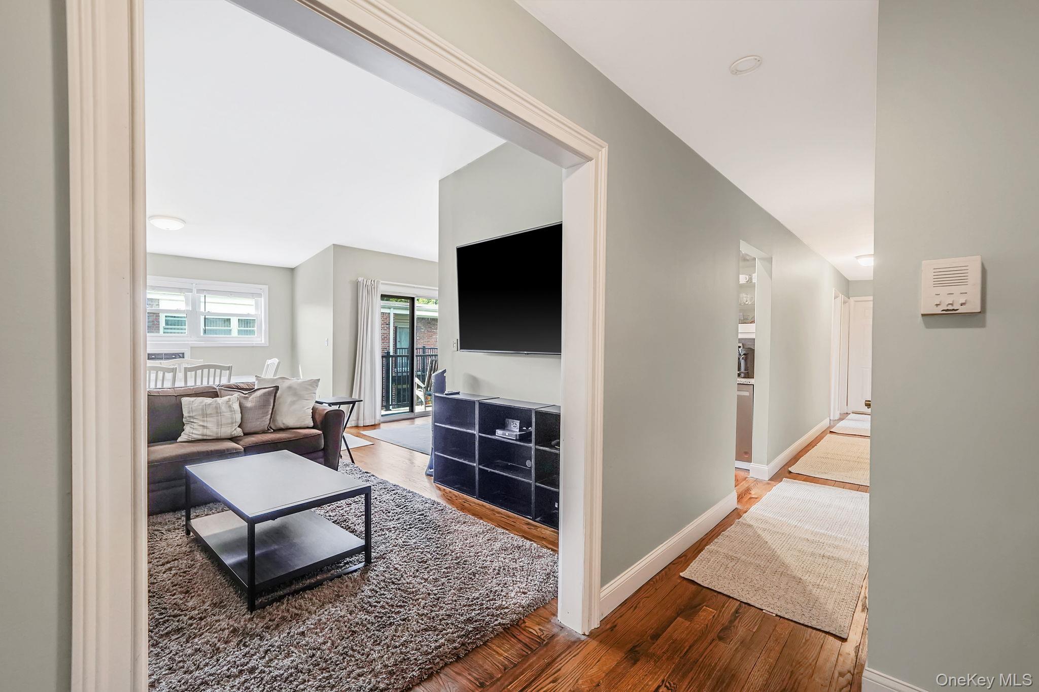 22 Ivy Street, Unit 6B Farmingdale, NY 11735 - Photo 6 of 26 a living room with furniture and a flat screen tv