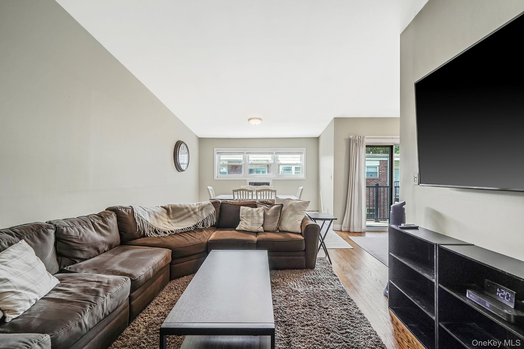 22 Ivy Street, Unit 6B Farmingdale, NY 11735 - Photo 7 of 26 a living room with a couch and a flat screen tv
