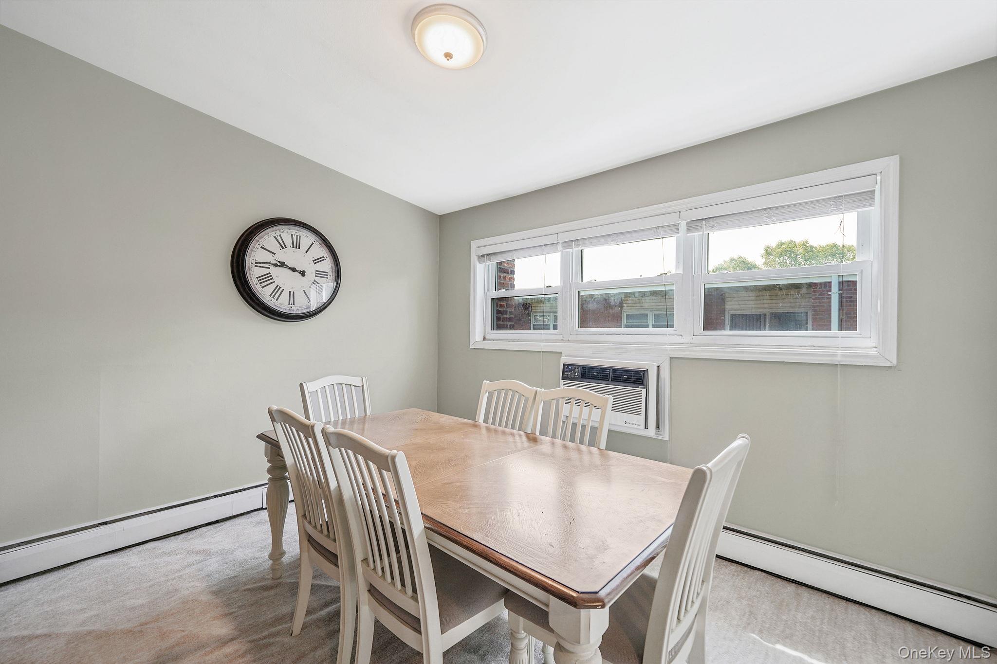 22 Ivy Street, Unit 6B Farmingdale, NY 11735 - Photo 10 of 26 a view of a dining room with furniture and a large window
