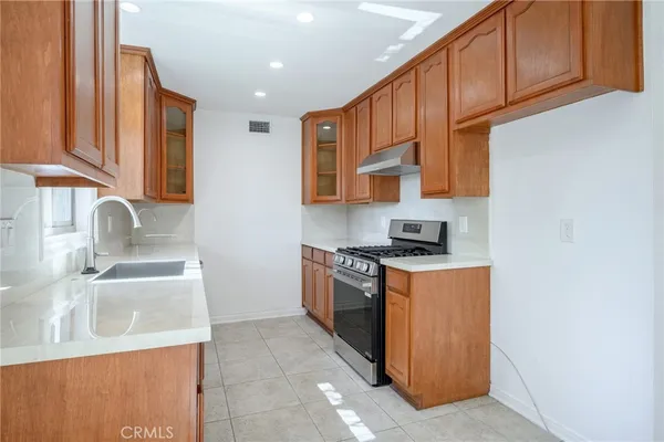 a kitchen with stainless steel appliances granite countertop a sink stove and refrigerator