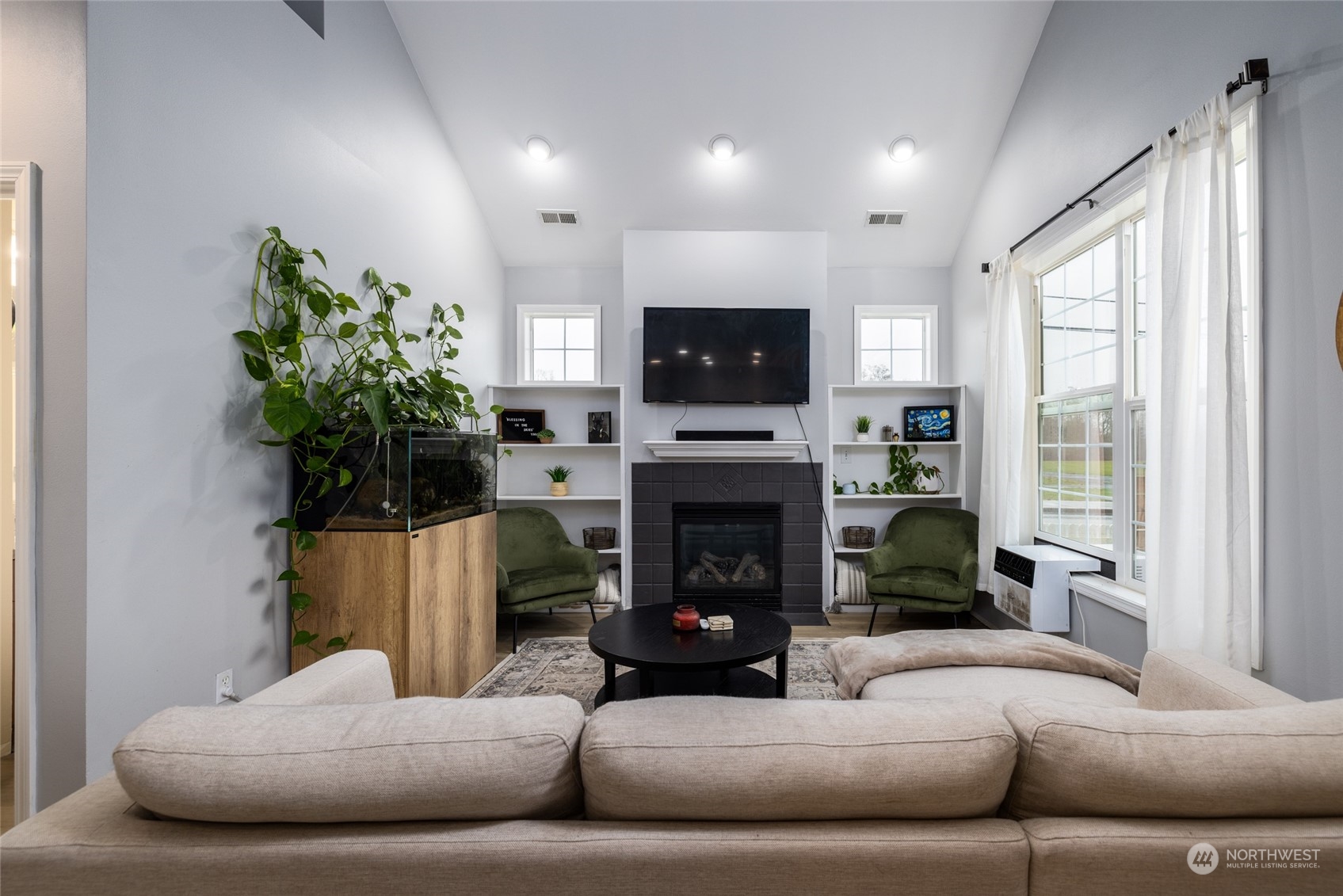 1505 Wildflower Way Sedro-Woolley, WA 98284 - Photo 11 of 24 a living room with furniture a flat screen tv and a fireplace