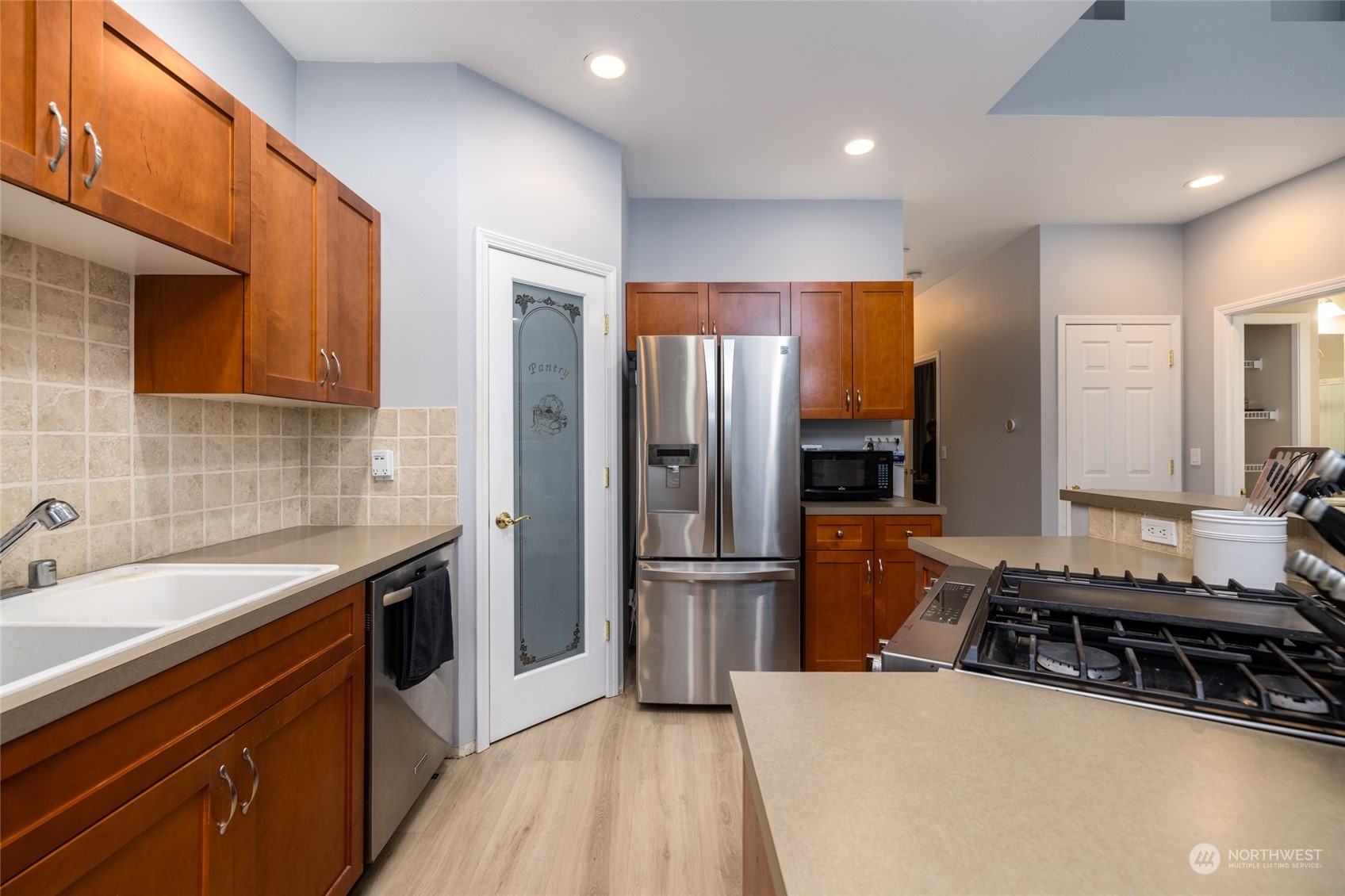 1505 Wildflower Way Sedro-Woolley, WA 98284 - Photo 13 of 24 a kitchen with stainless steel appliances granite countertop a refrigerator and a sink