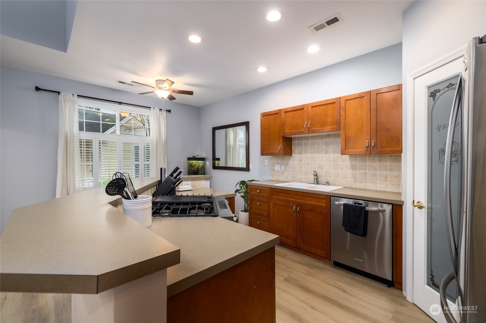 1505 Wildflower Way Sedro-Woolley, WA 98284 - Photo 15 of 24 a kitchen with stainless steel appliances granite countertop a sink a stove and a refrigerator