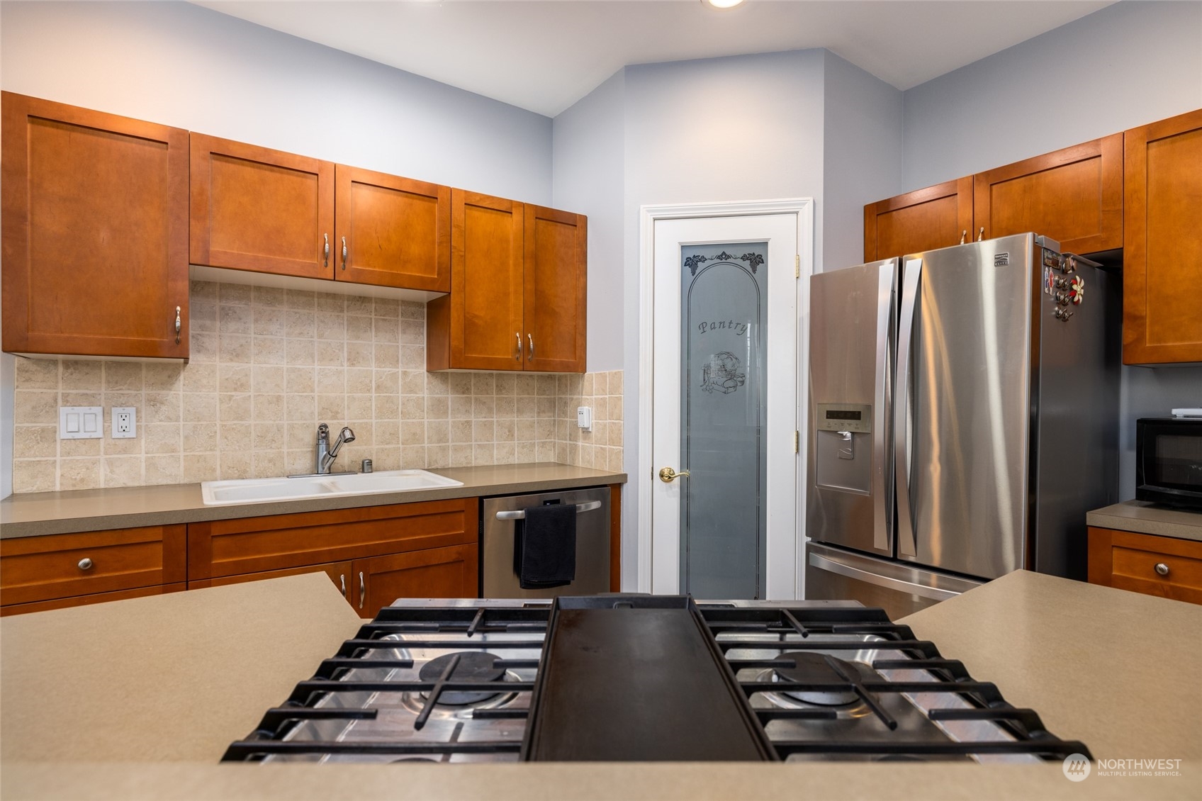 1505 Wildflower Way Sedro-Woolley, WA 98284 - Photo 16 of 24 a kitchen with stainless steel appliances a stove a sink and a refrigerator