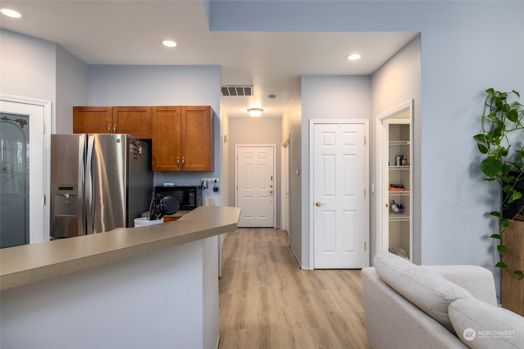 1505 Wildflower Way Sedro-Woolley, WA 98284 - Photo 3 of 24 a view of a kitchen with a refrigerator and a living room