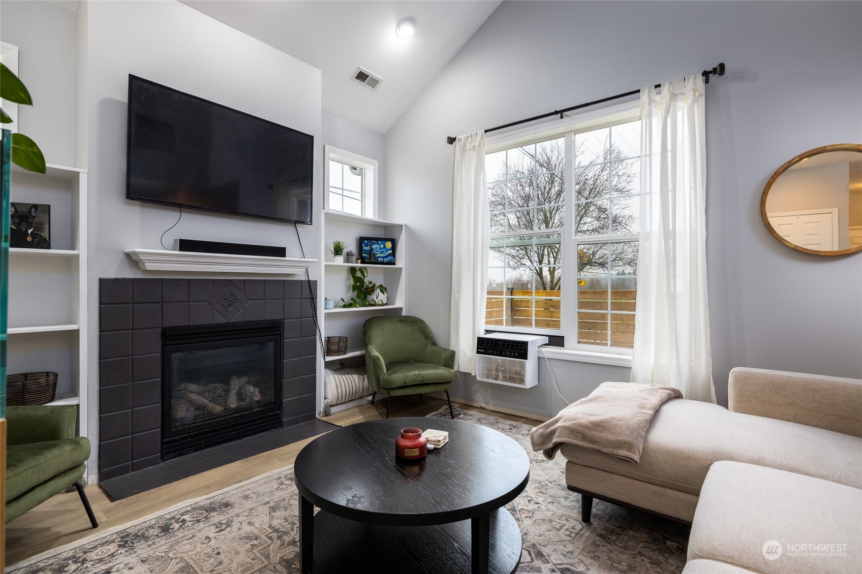 1505 Wildflower Way Sedro-Woolley, WA 98284 - Photo 10 of 24 a living room with furniture a fireplace and a flat screen tv