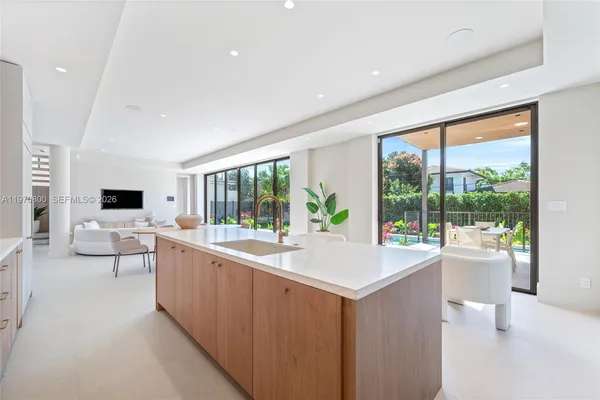 a living room with furniture a large window and a flat screen tv