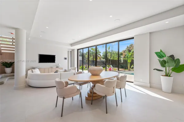 a dining room with furniture window and outdoor view