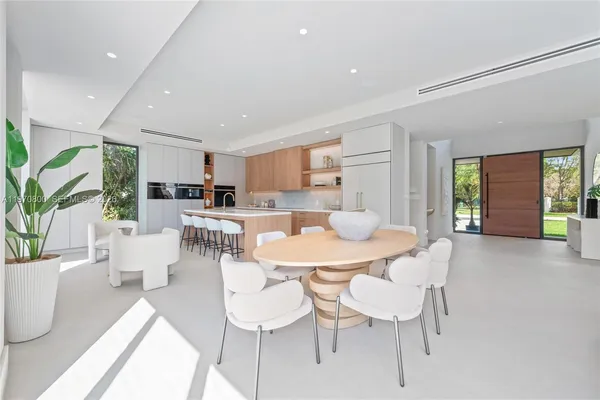 a view of a dining room with furniture and a potted plant