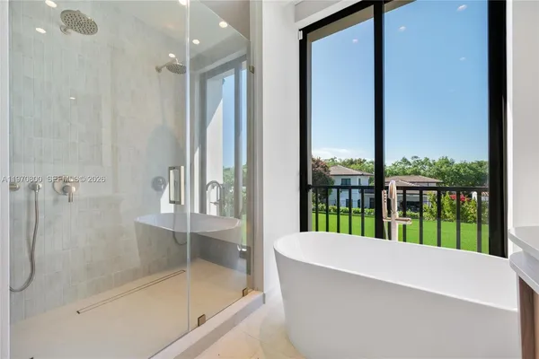 a bathroom with a bathtub and a shower