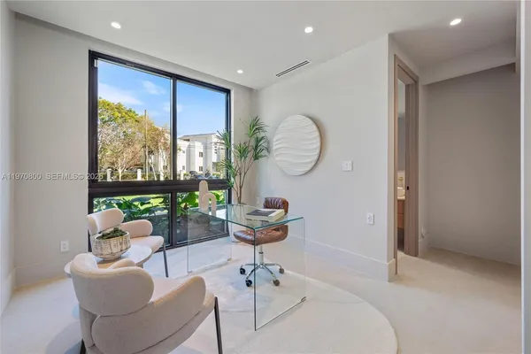 a living room with fireplace furniture and a large window
