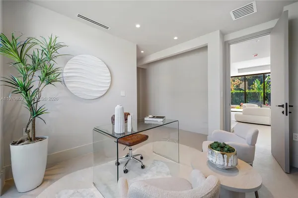 a living room with furniture and a potted plant