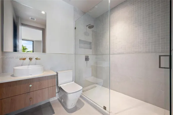 a bathroom with a toilet sink and shower