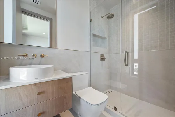 a bathroom with a toilet sink and shower
