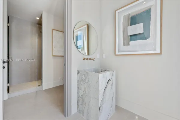 a bathroom with a mirror and a shower