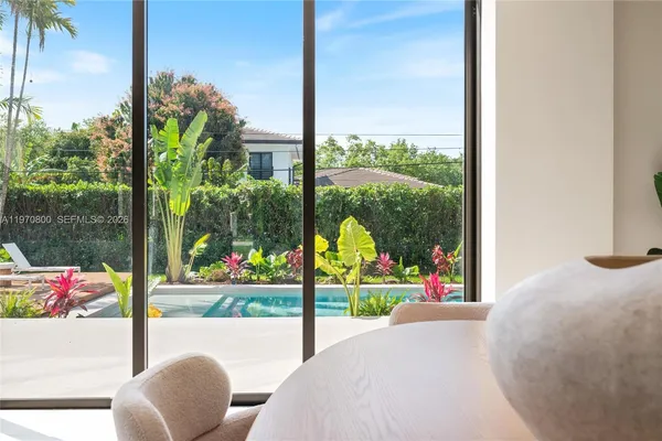 a view of a porch with furniture and garden view
