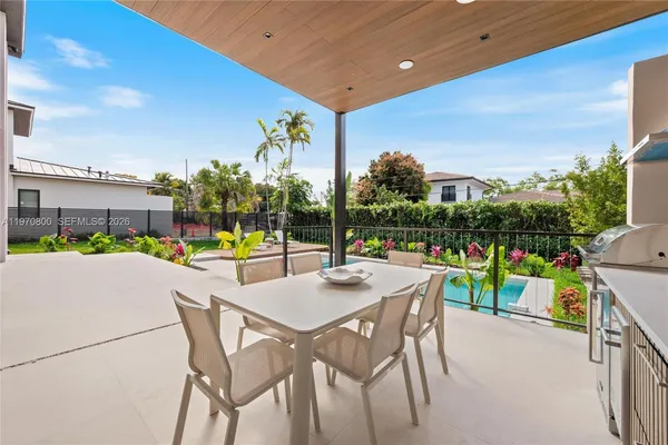 a view of an chairs and table in patio