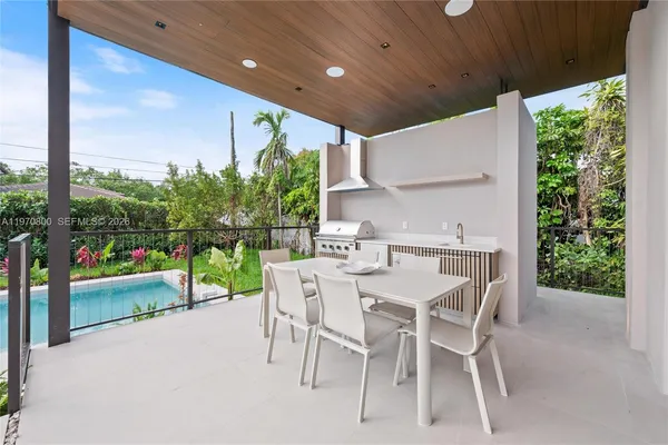 a dining area with a table and chairs