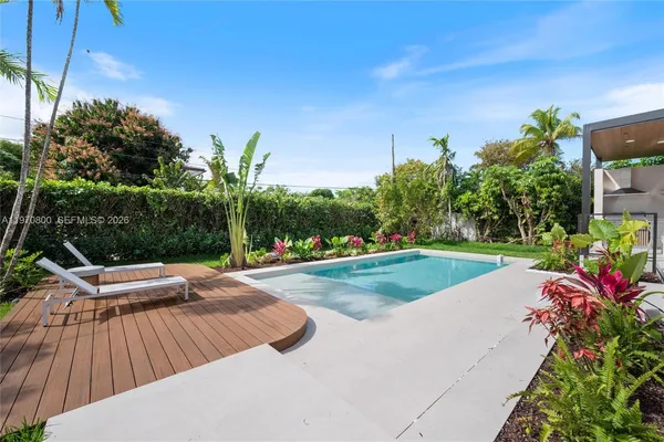 a view of a backyard with sitting area