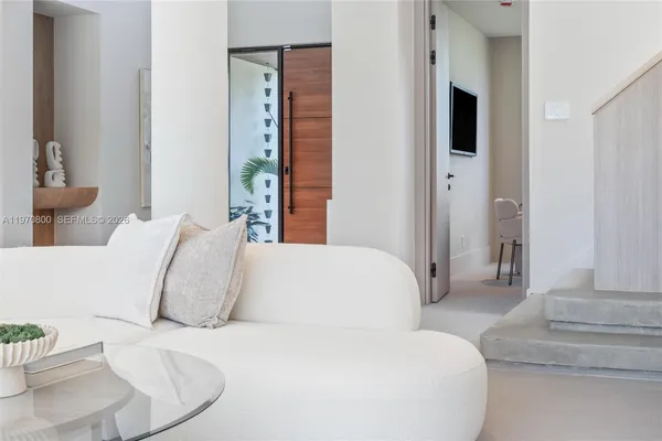 a large white bed in a white room