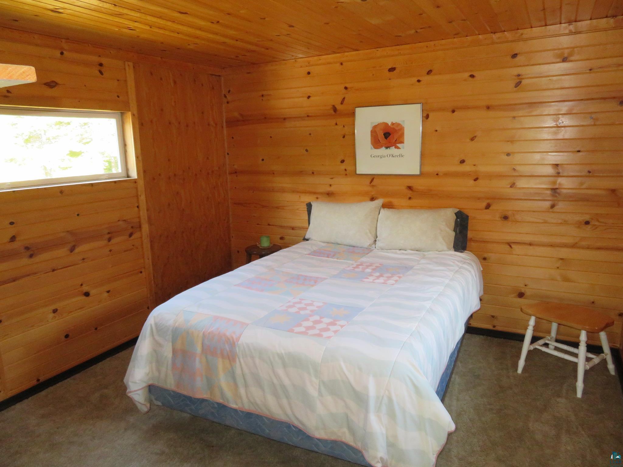 1268 Tom Lake Road Hovland, MN 55606 - Photo 19 of 56 Carpeted bedroom with wood walls and wooden ceiling