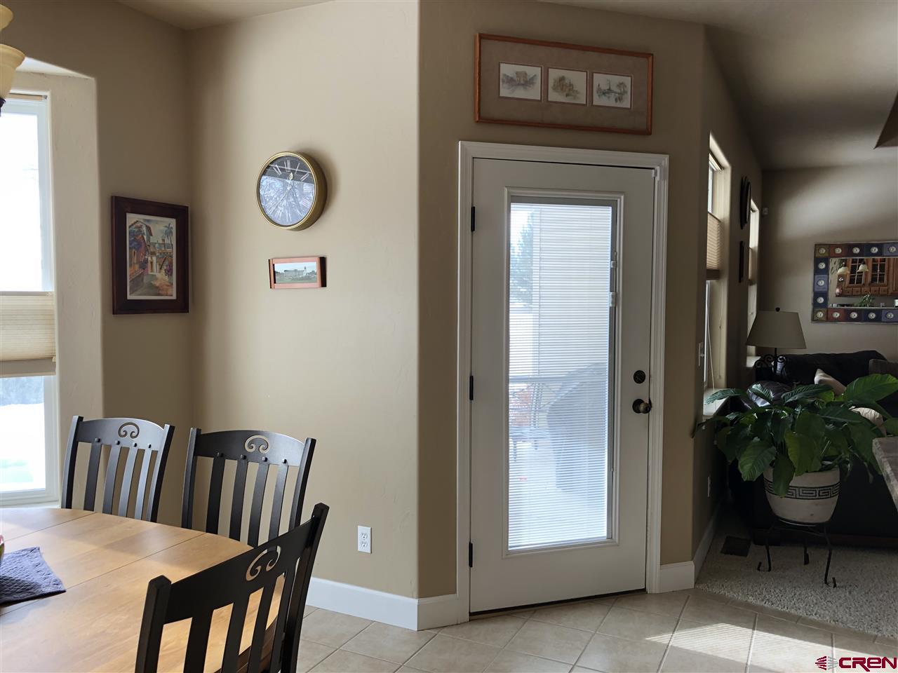 3016 Outlook Road Montrose, CO 81401 - Photo 18 of 30 looking out to the patio. Door with enclosed blinds.