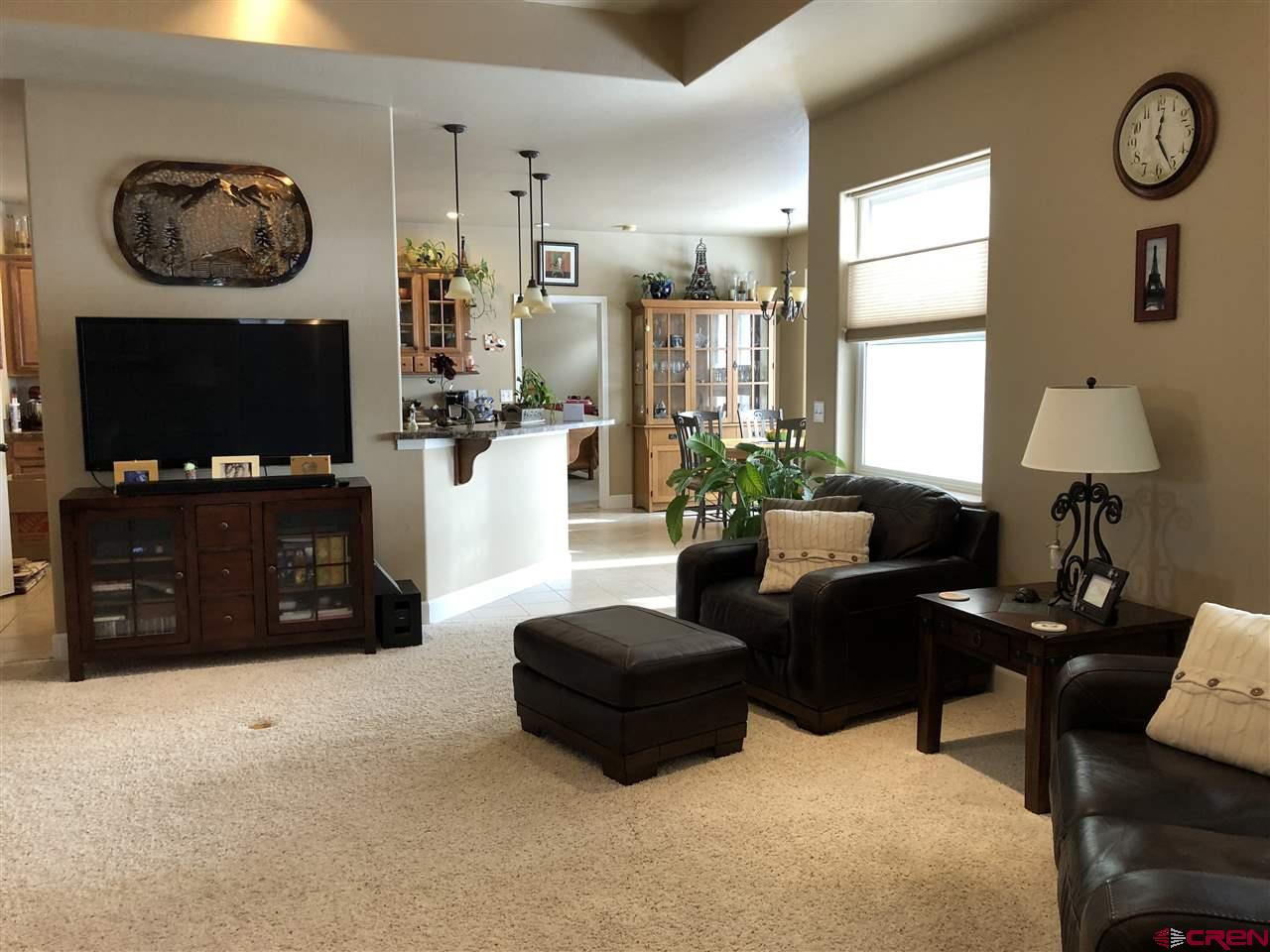 3016 Outlook Road Montrose, CO 81401 - Photo 5 of 30 from the hall looking into the living/great towards the dining & kitchen areas.