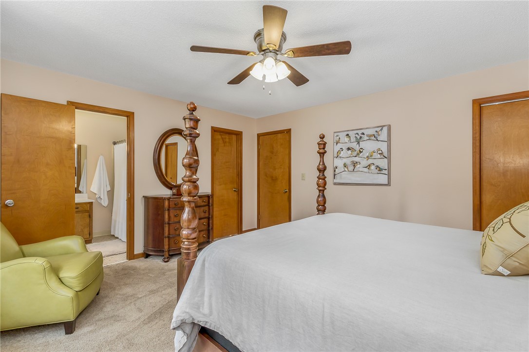 207 Laurel Ridge Road Anderson, SC 29621 - Photo 42 of 50 A well-lit bedroom features plush carpeting and convenient access to an en-suite bathroom.