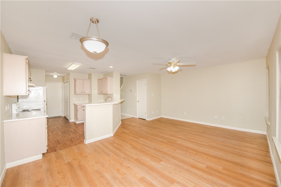 9710 Sugar Hill Drive, Unit A Austin, TX 78748 - Photo 12 of 40 a view of a kitchen with a sink and dishwasher a refrigerator with wooden floor