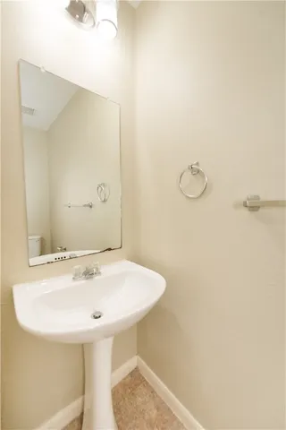 a white toilet sitting next to a shower