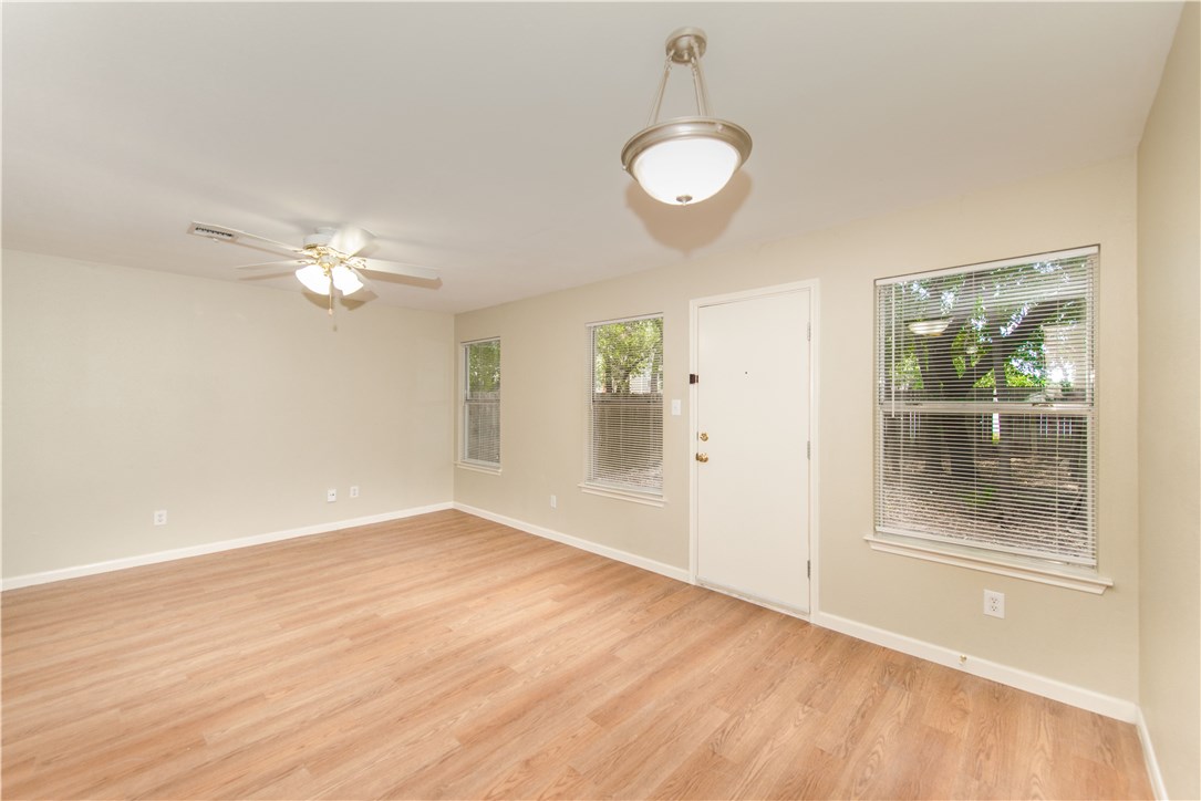 9710 Sugar Hill Drive, Unit A Austin, TX 78748 - Photo 18 of 40 an empty room with wooden floor fan and windows