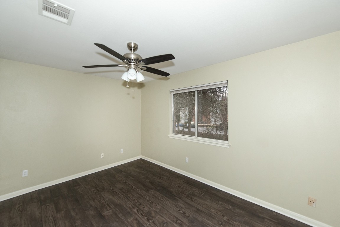9710 Sugar Hill Drive, Unit A Austin, TX 78748 - Photo 21 of 40 an empty room with wooden floor and ceiling fan