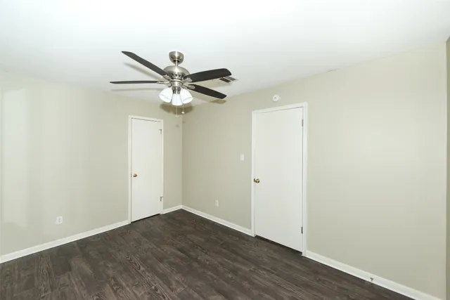 a view of a room with a ceiling fan and a window