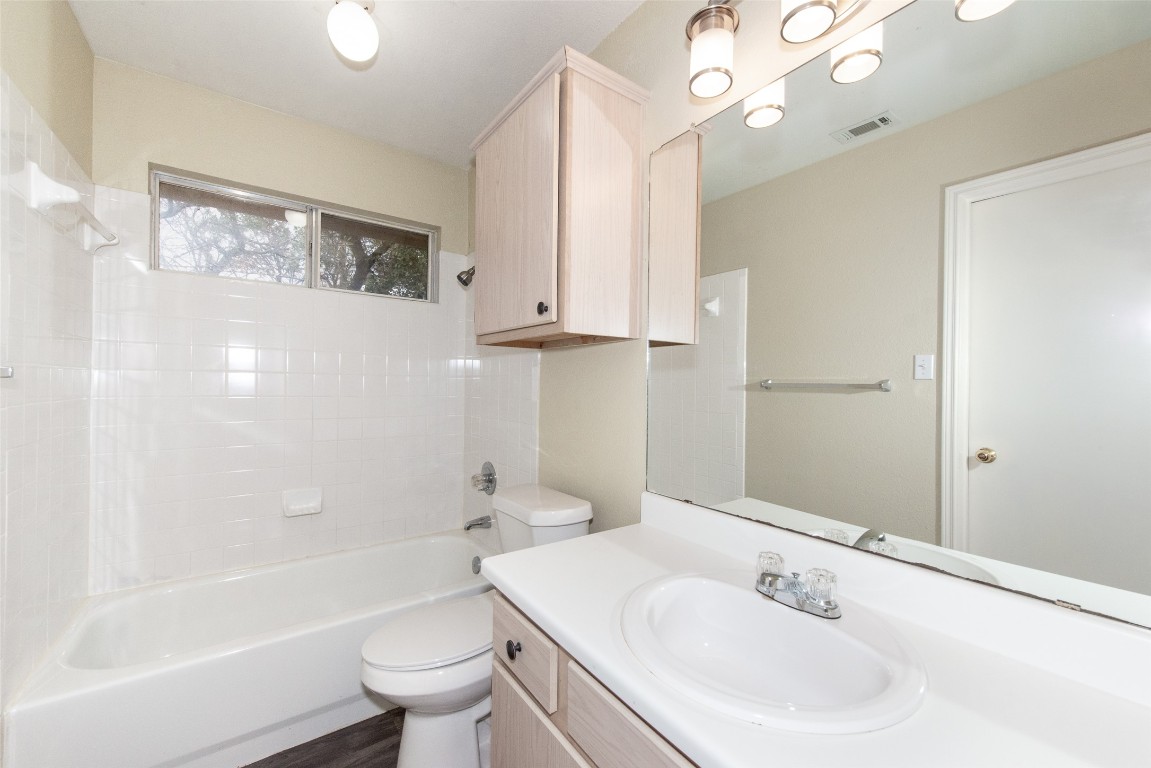 9710 Sugar Hill Drive, Unit A Austin, TX 78748 - Photo 24 of 40 a bathroom with a sink a toilet and shower