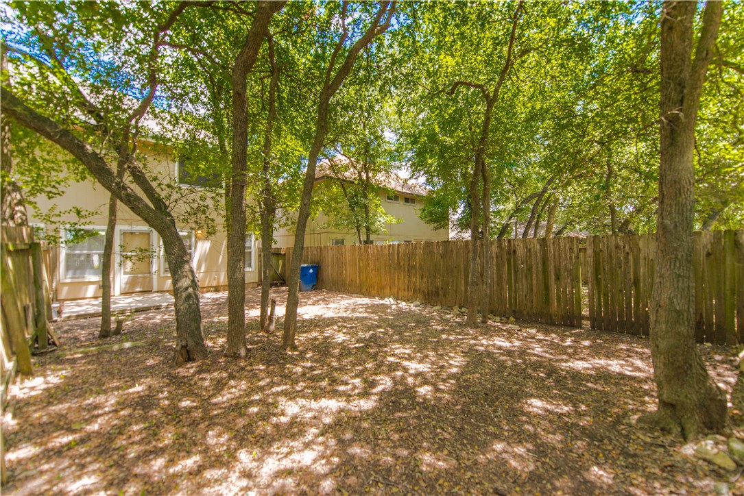 9710 Sugar Hill Drive, Unit A Austin, TX 78748 - Photo 32 of 40 a backyard of a house with lots of green space and fountain