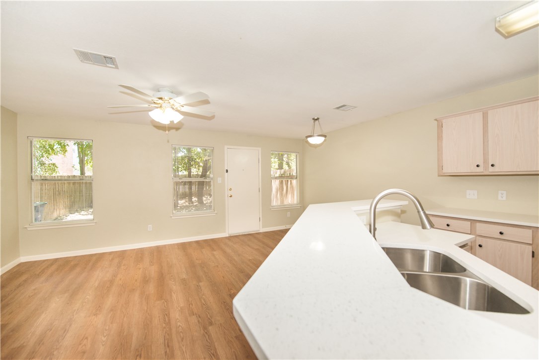 9710 Sugar Hill Drive, Unit A Austin, TX 78748 - Photo 4 of 40 a view of a kitchen with a sink cabinets and wooden floor