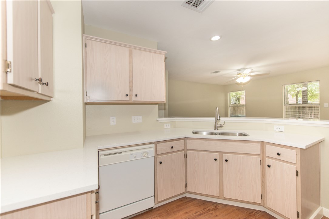 9710 Sugar Hill Drive, Unit A Austin, TX 78748 - Photo 5 of 40 a kitchen with white cabinets and sink