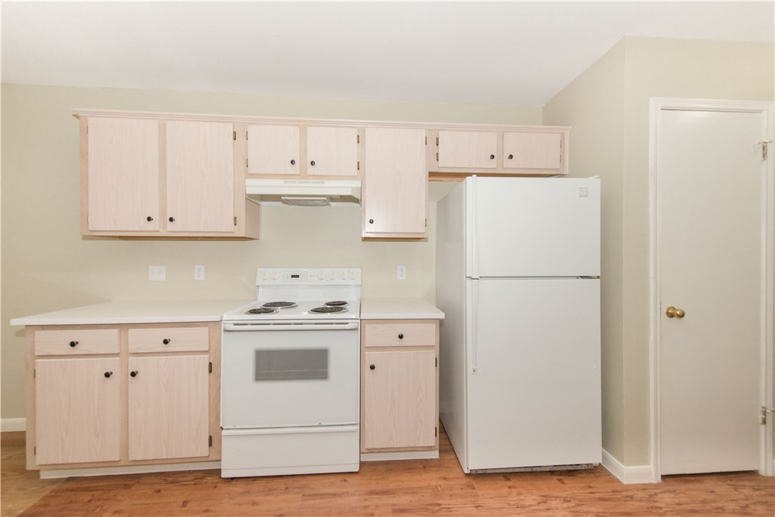 9710 Sugar Hill Drive, Unit A Austin, TX 78748 - Photo 7 of 40 a kitchen with cabinets appliances wooden floor and a window