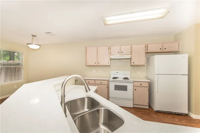 a kitchen with a sink a stove and refrigerator
