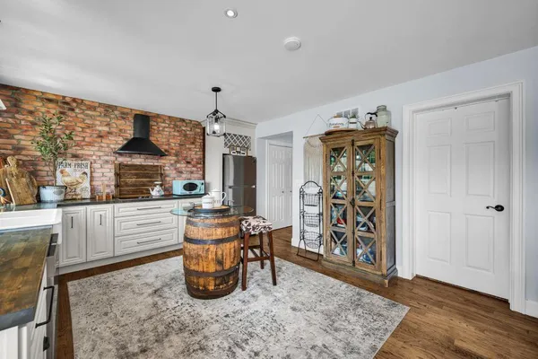 a kitchen with stainless steel appliances granite countertop a refrigerator and a stove top oven