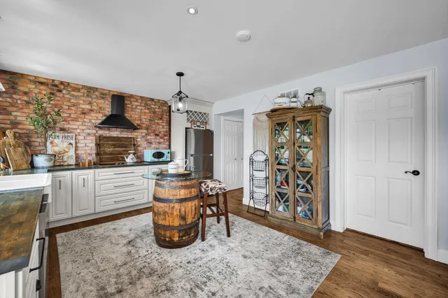 a kitchen with stainless steel appliances granite countertop a refrigerator and a stove top oven