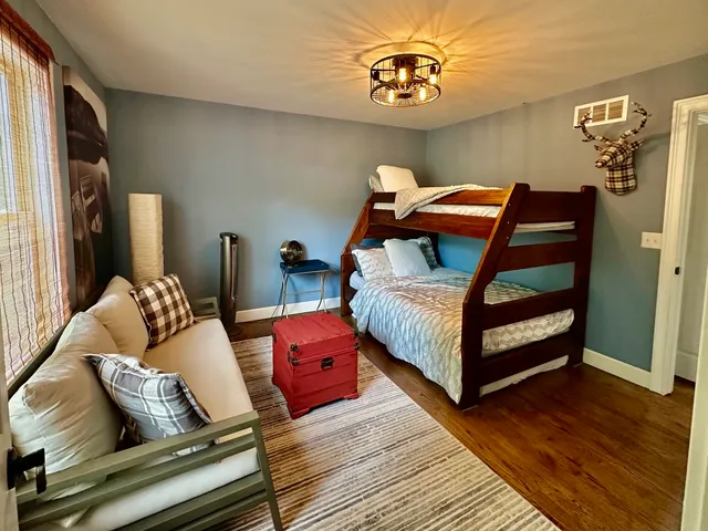 a bedroom with furniture and a wooden floor