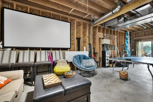 a living room with furniture and a book shelf